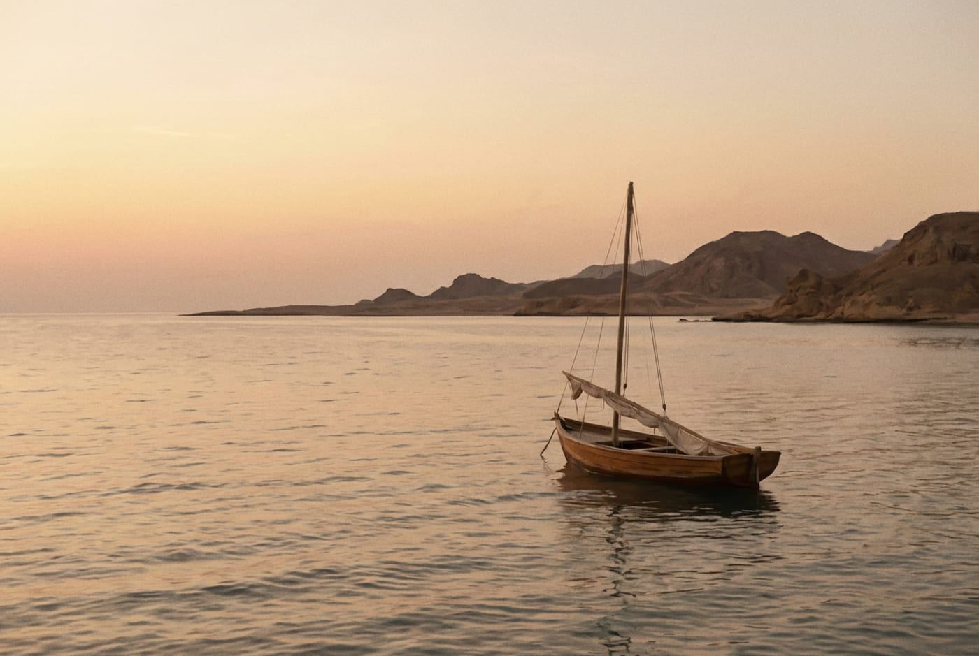 Illustration of a small boat on the Red Sea near the African coast at dawn